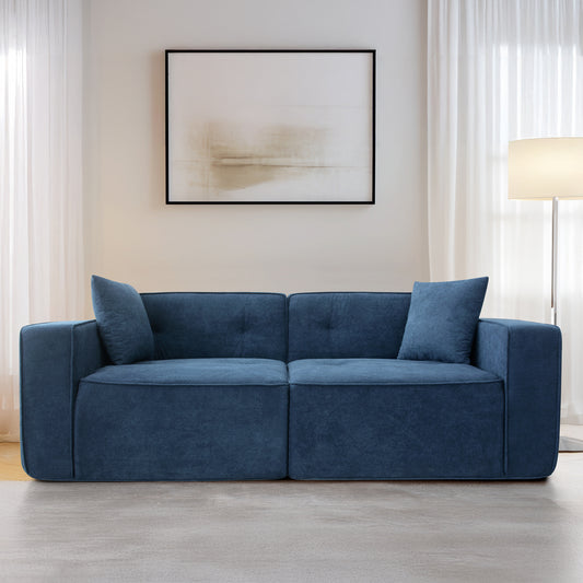 Deep blue upholstered sofa with square arms and two matching throw pillows