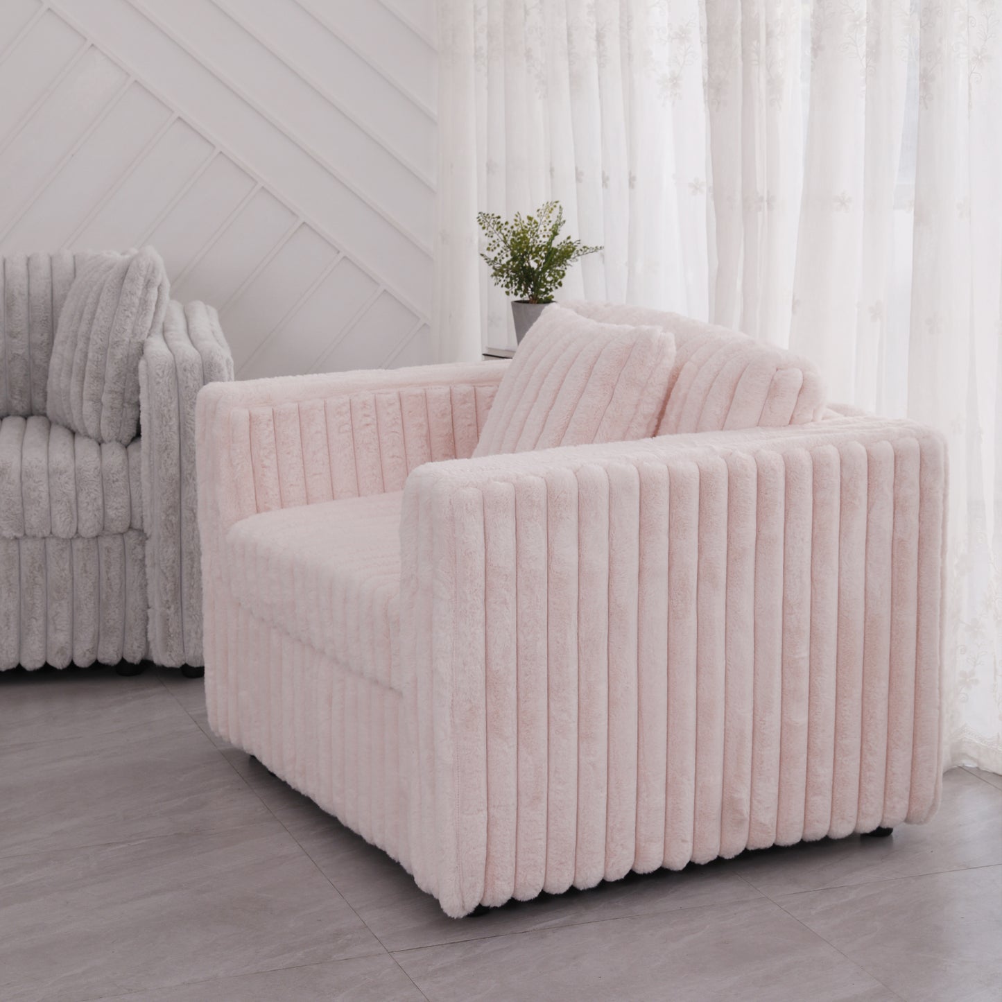Soft pink plush accent chair with vertical channel tufting and comfortable cushions