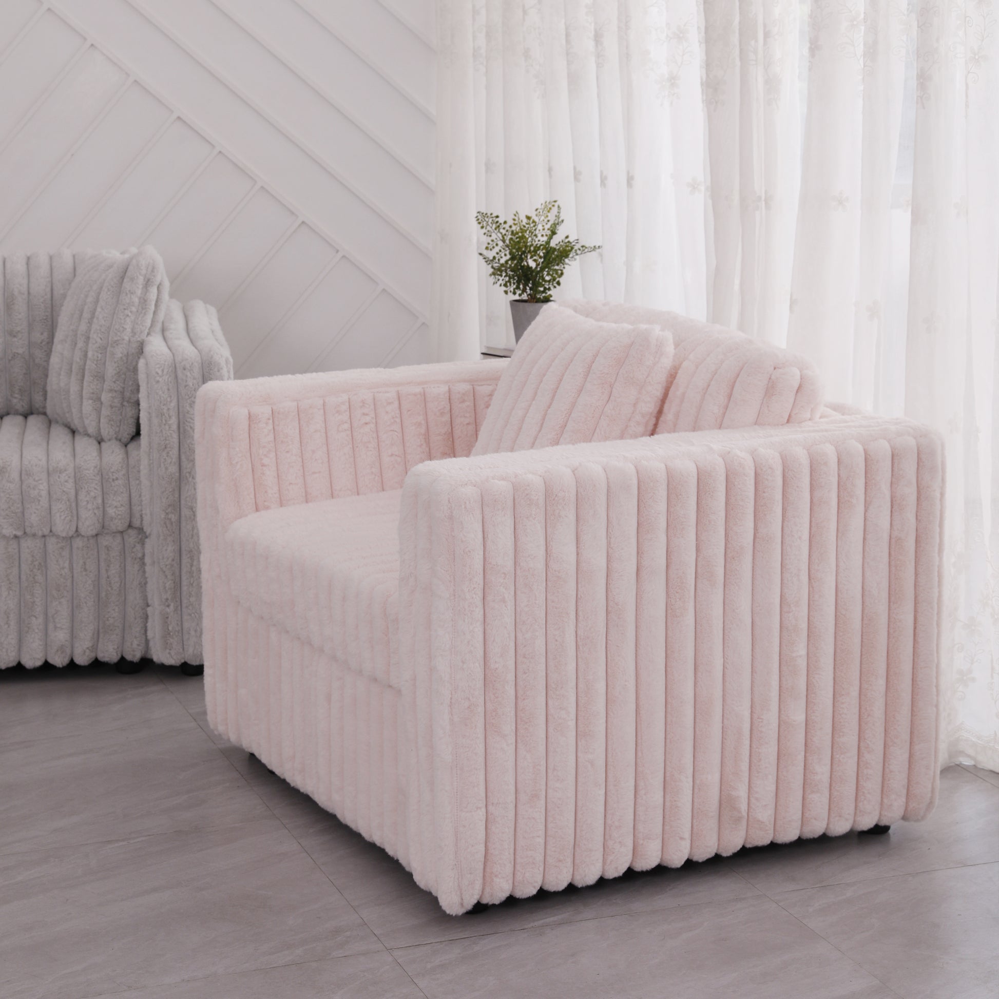 Soft pink plush accent chair with vertical channel tufting and comfortable cushions