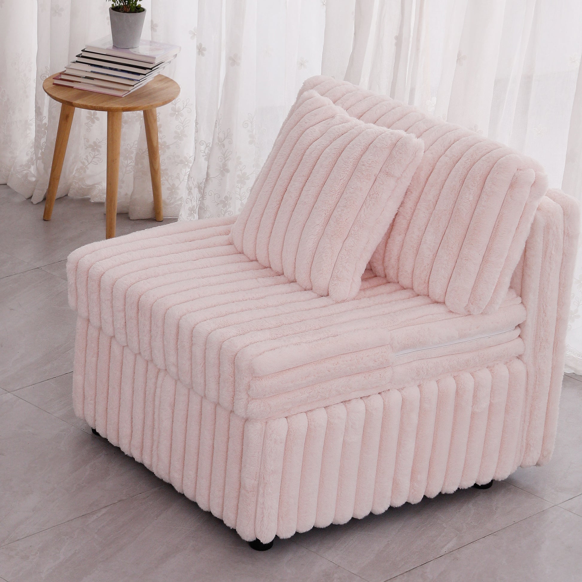 Plush pink accent chair with ribbed texture and two cushions perfect for a cozy reading nook
