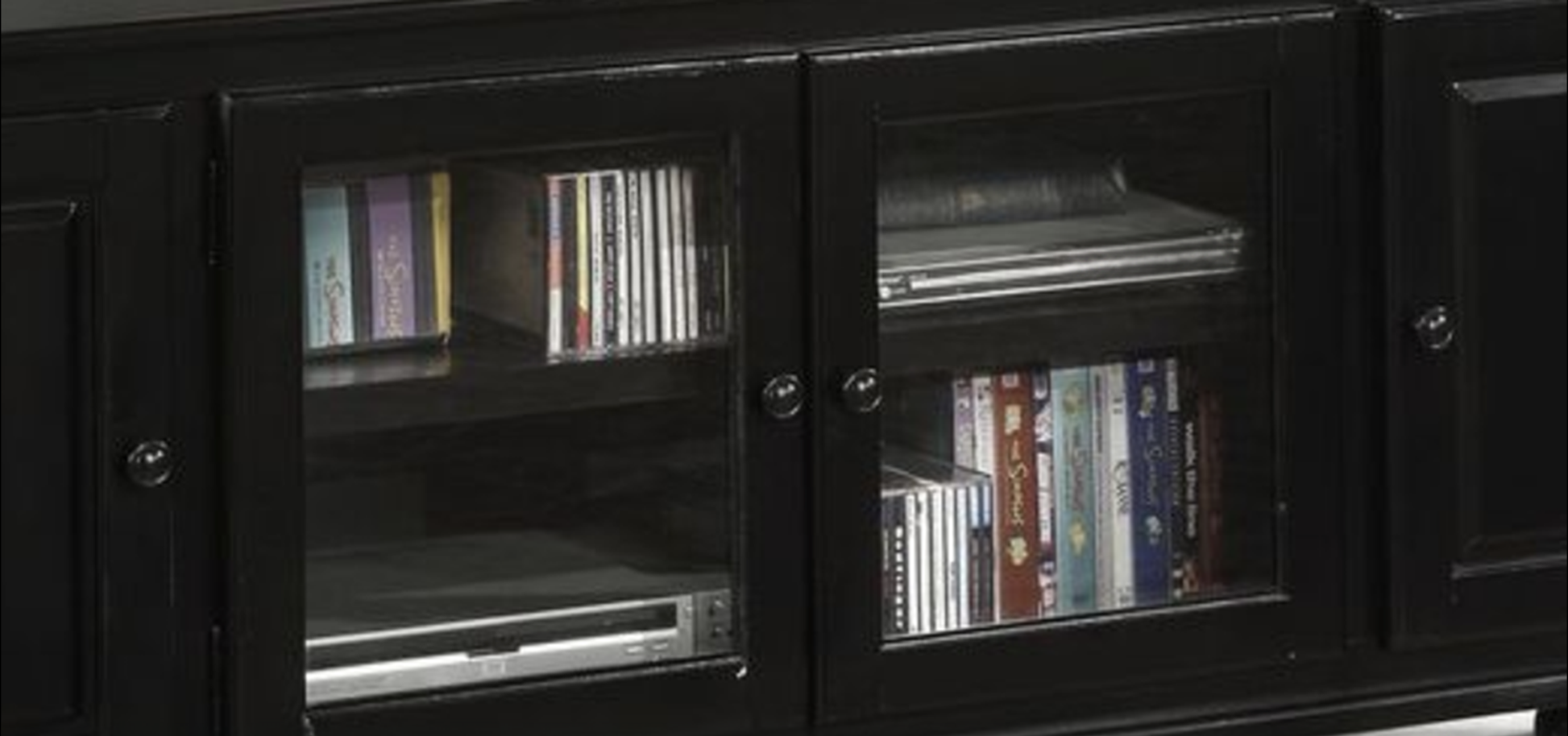 Black media cabinet with glass doors storing CDs and DVDs neatly on shelves