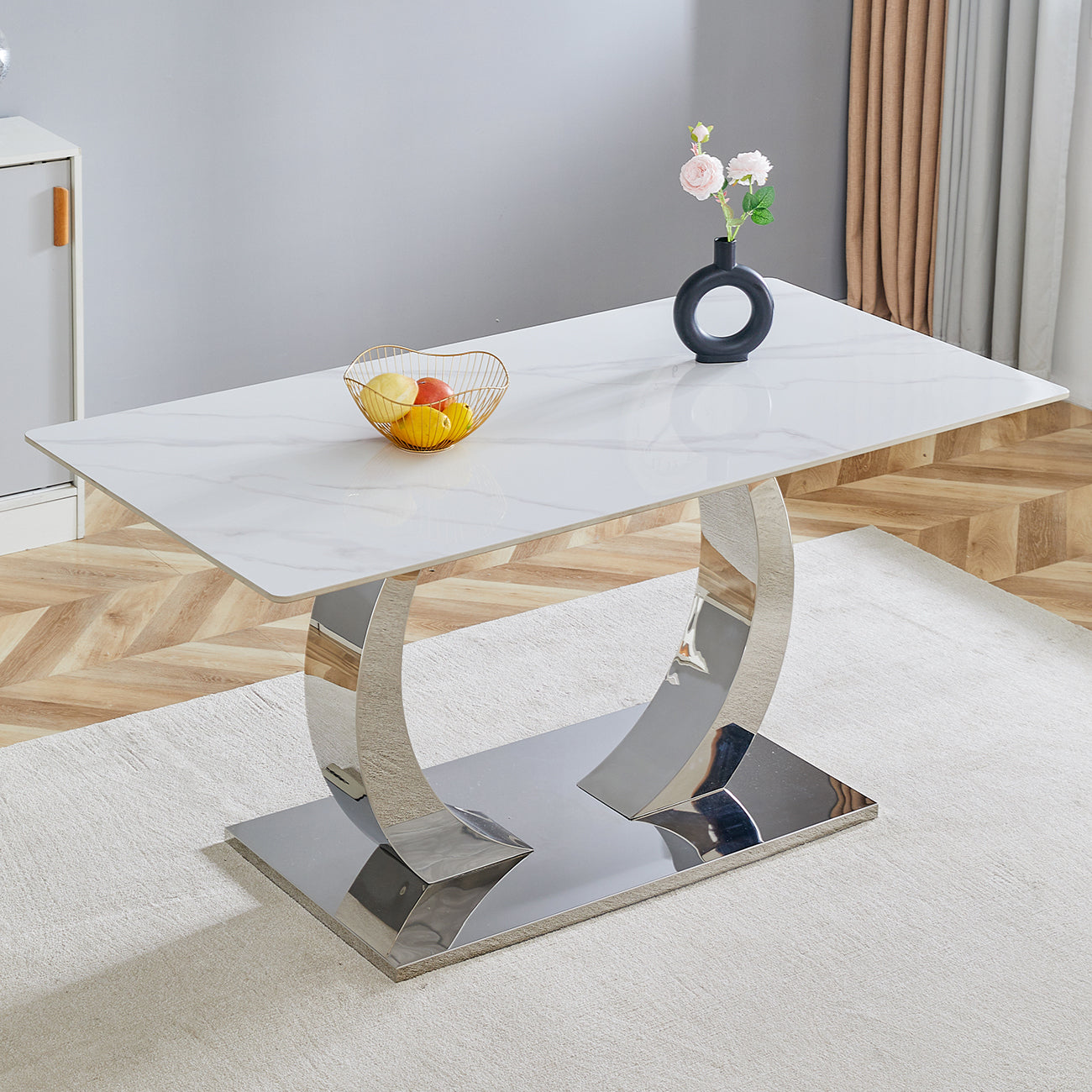 Modern white marble dining table with a polished chrome pedestal base