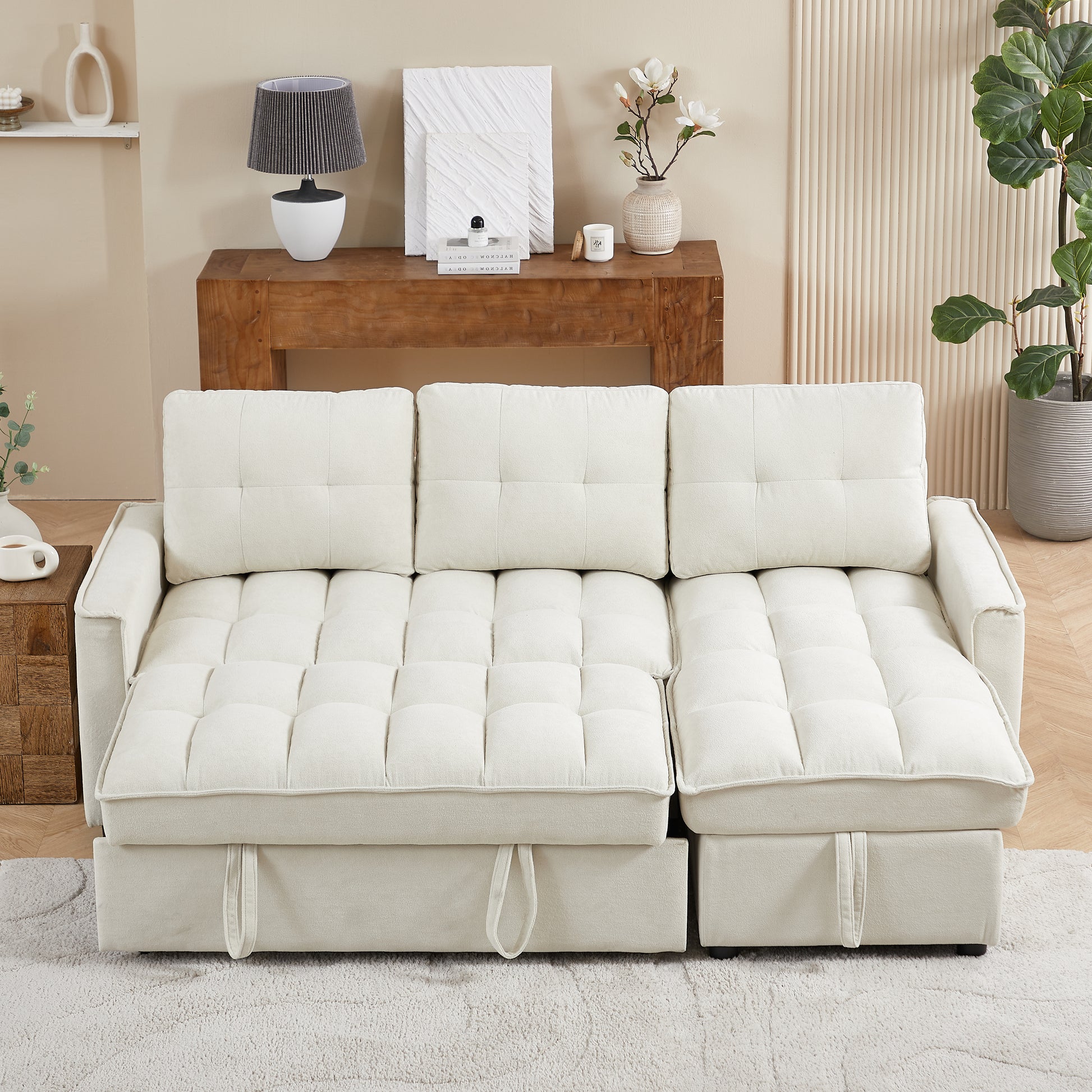 Tufted cream sofa bed with hidden storage compartments and plush cushions perfect for small spaces