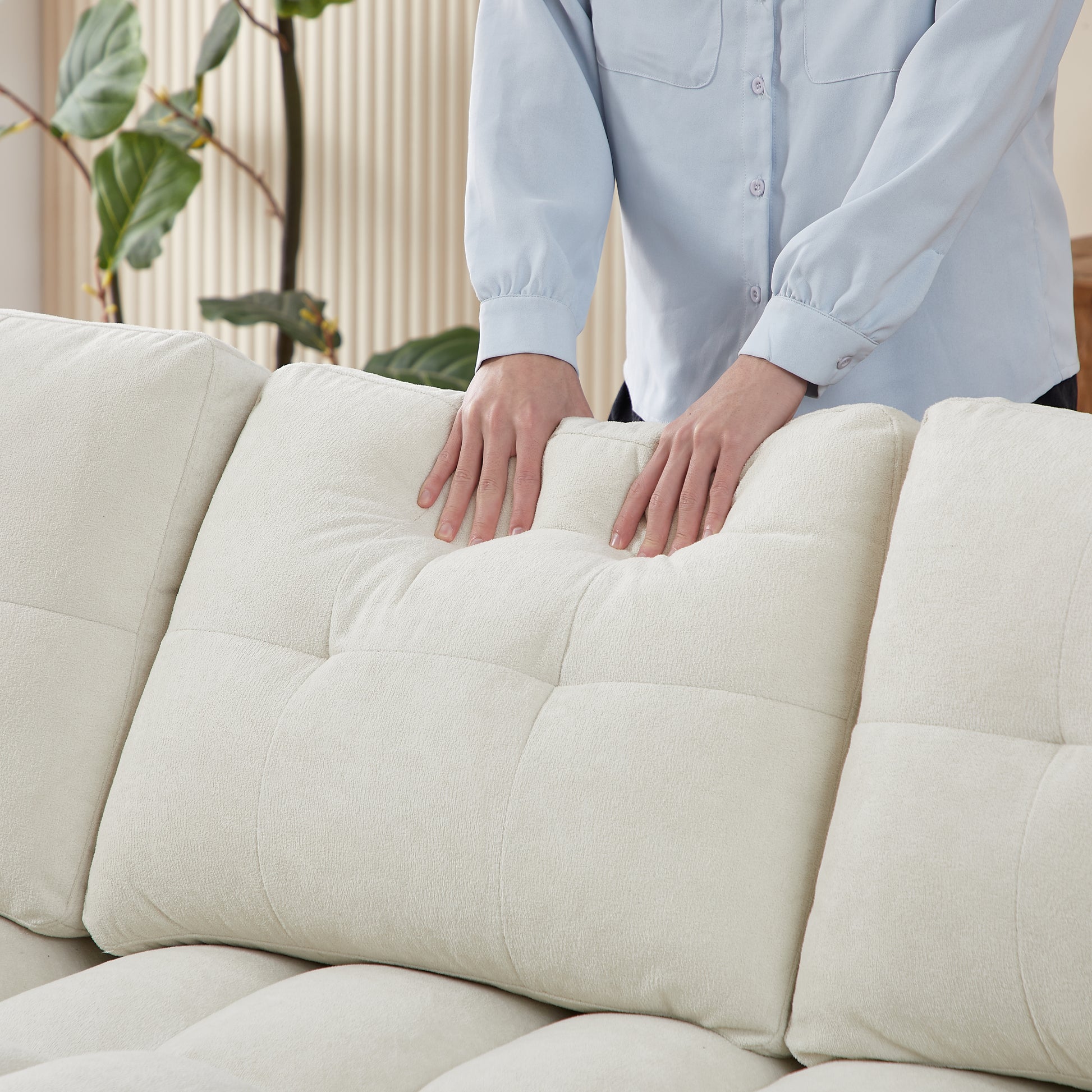 Cream boucl sectional sofa with tufted back cushions and plush arms