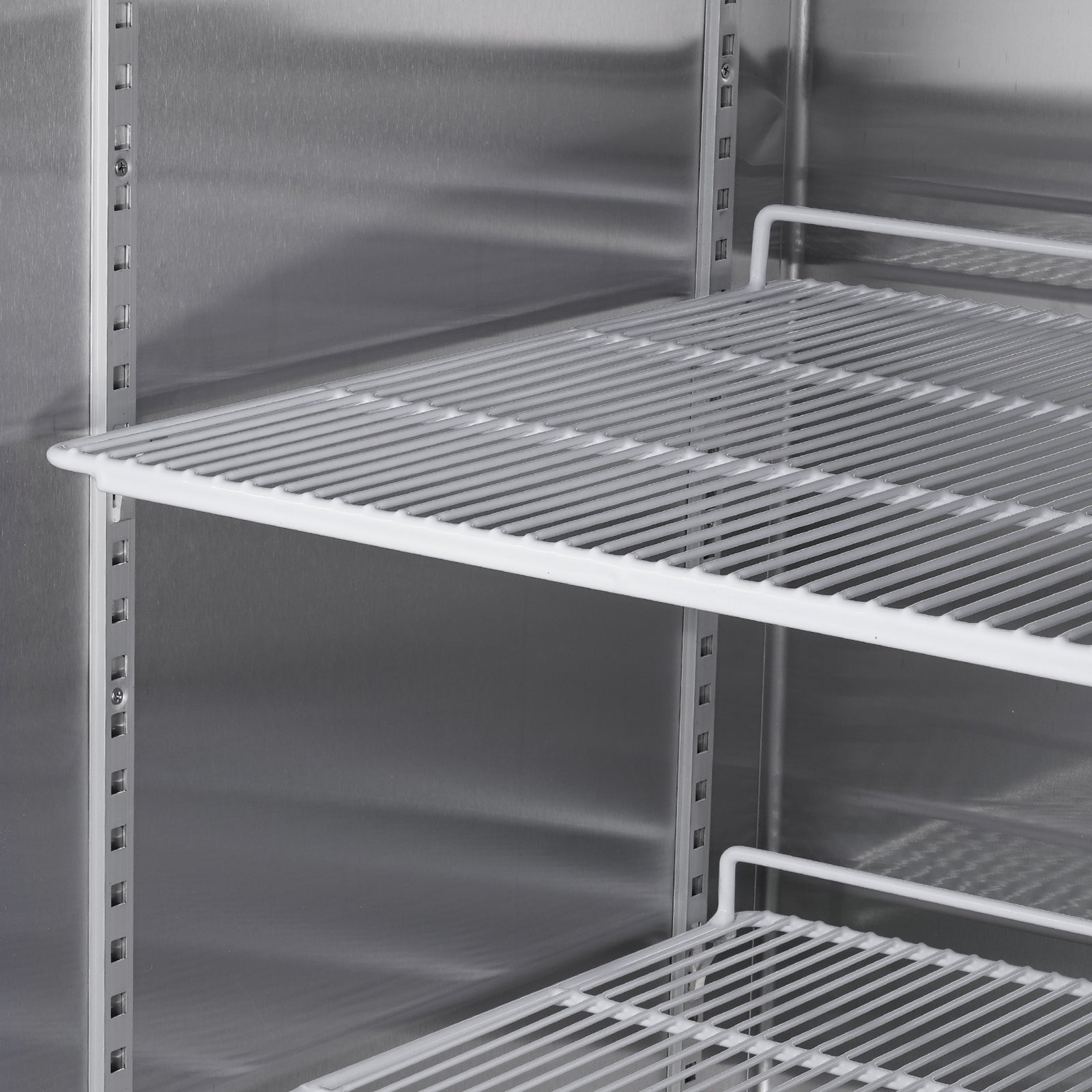 Stainless steel commercial refrigerator interior with wire shelves