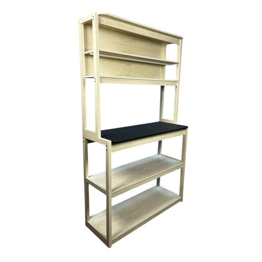 Distressed cream bakers rack with black countertop and open shelving
