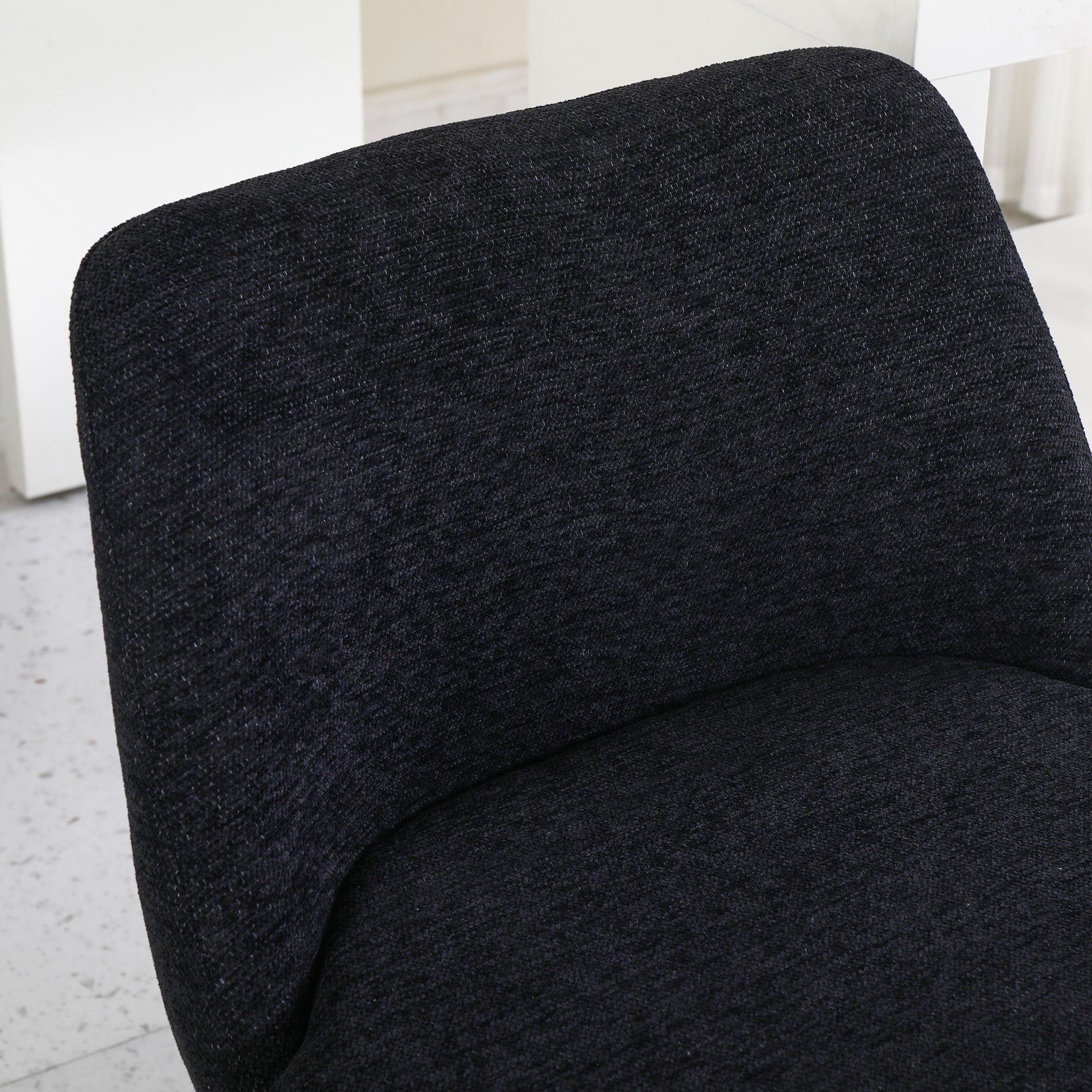 Textured black upholstered accent chair back providing a modern look for your living space