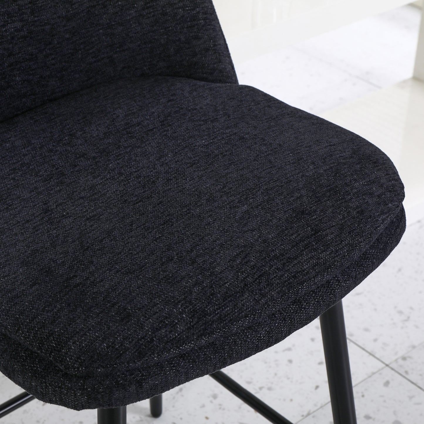 Textured black fabric on a comfortable bar stool seat ideal for modern kitchens