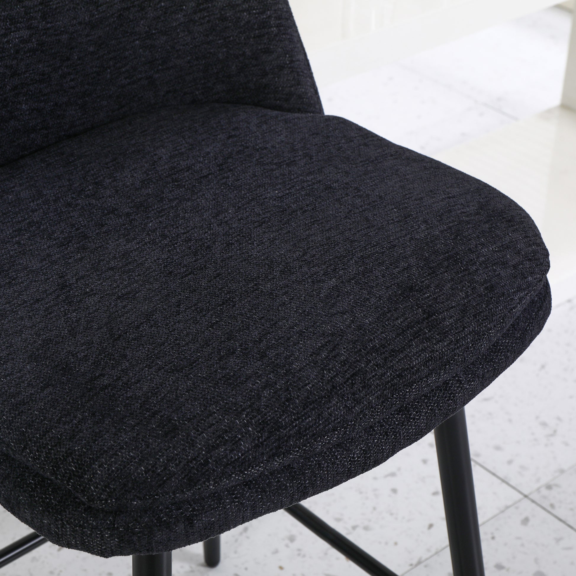 Textured black fabric on a comfortable bar stool seat ideal for modern kitchens