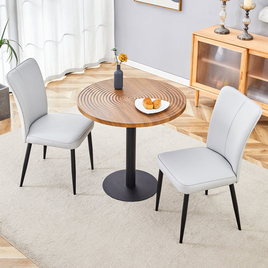Light gray faux leather dining chair with black metal legs