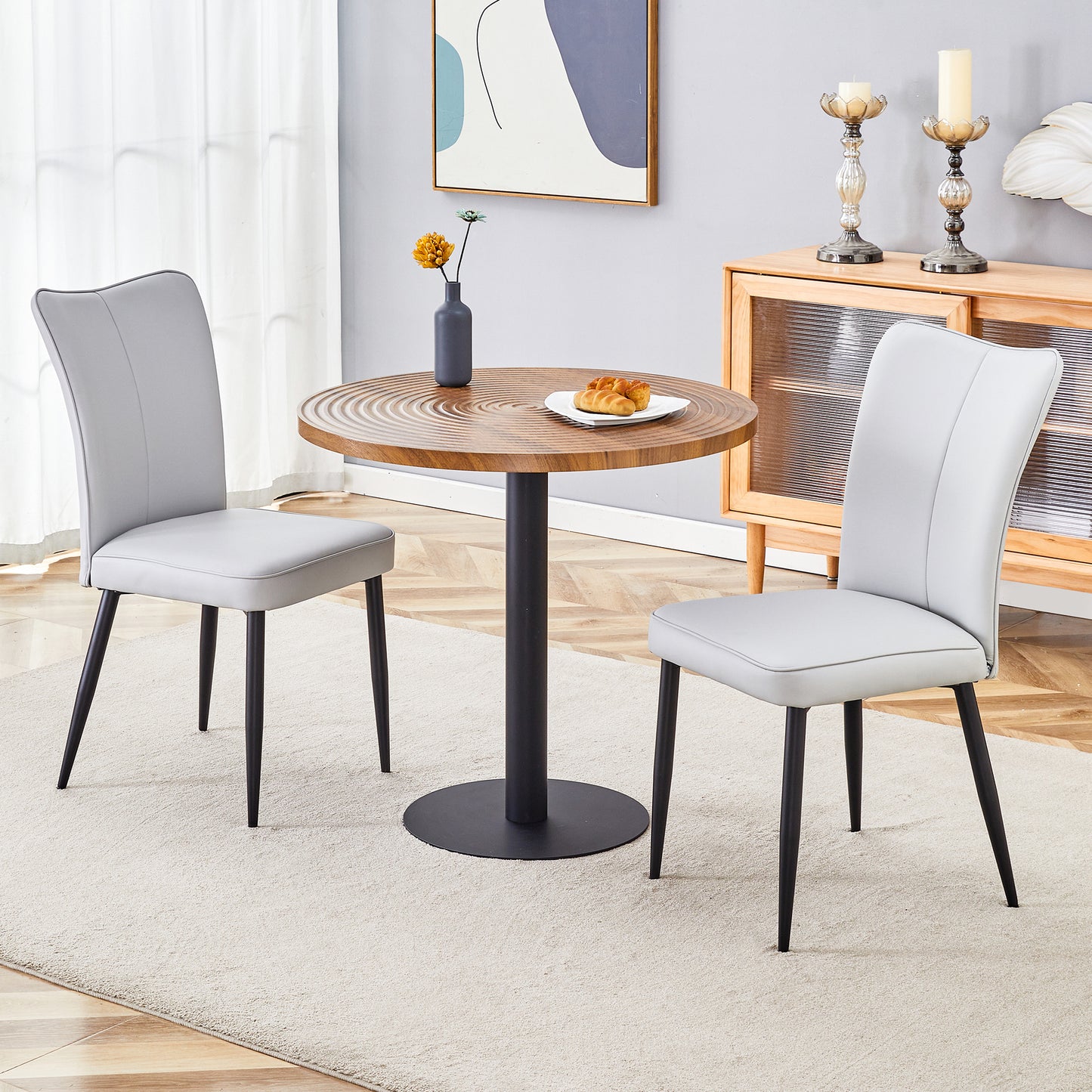 Gray faux leather dining chair with black metal legs sold as a set of two