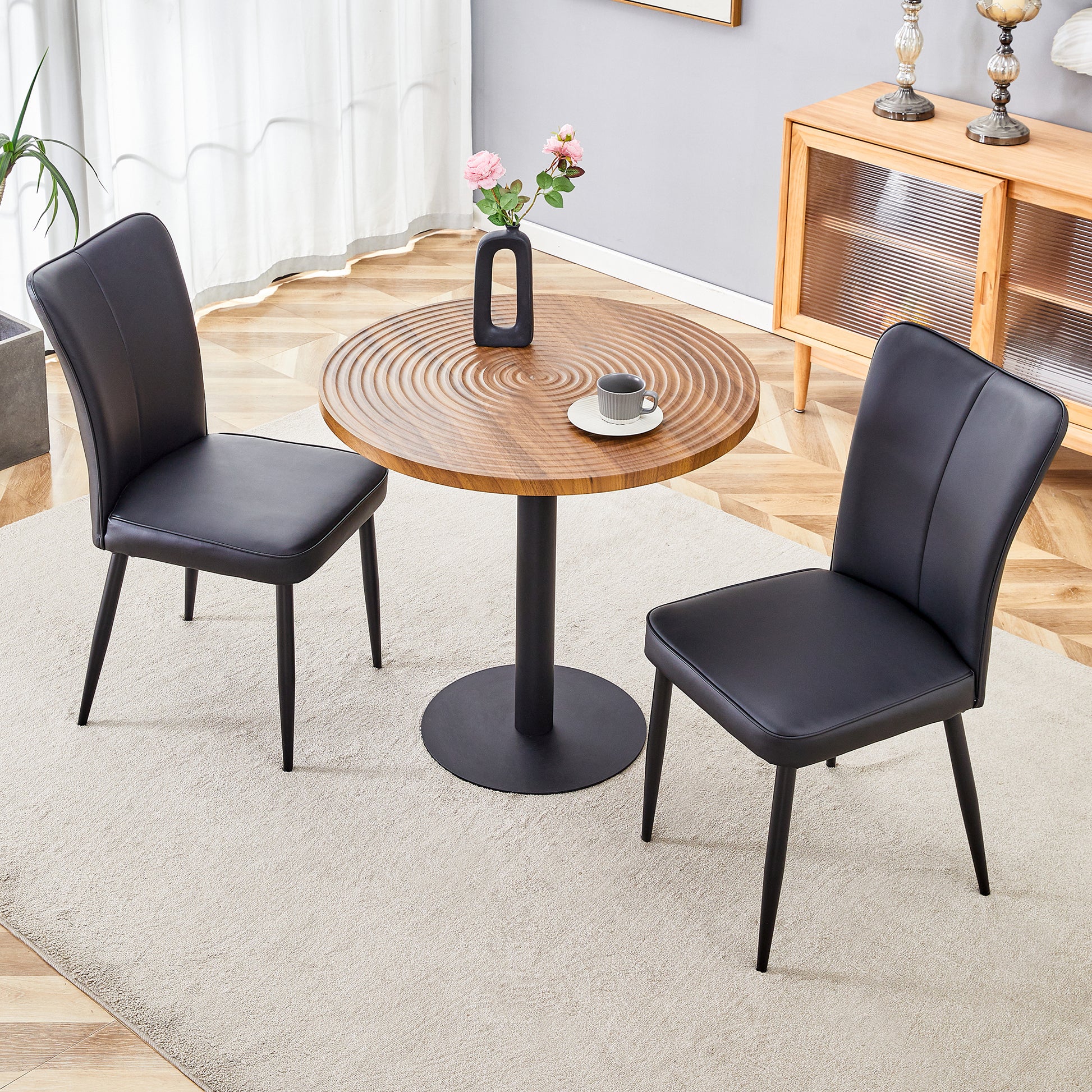 Black faux leather dining chair with slim metal legs ideal for modern kitchens
