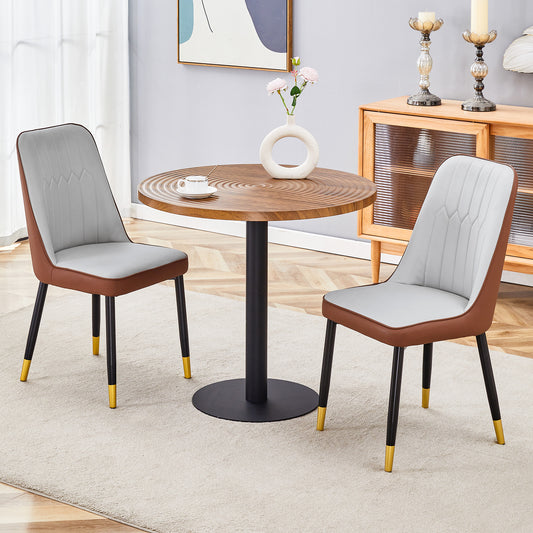 Modern accent chair with grey cushioned seat and brown vegan leather trim and gold tipped legs