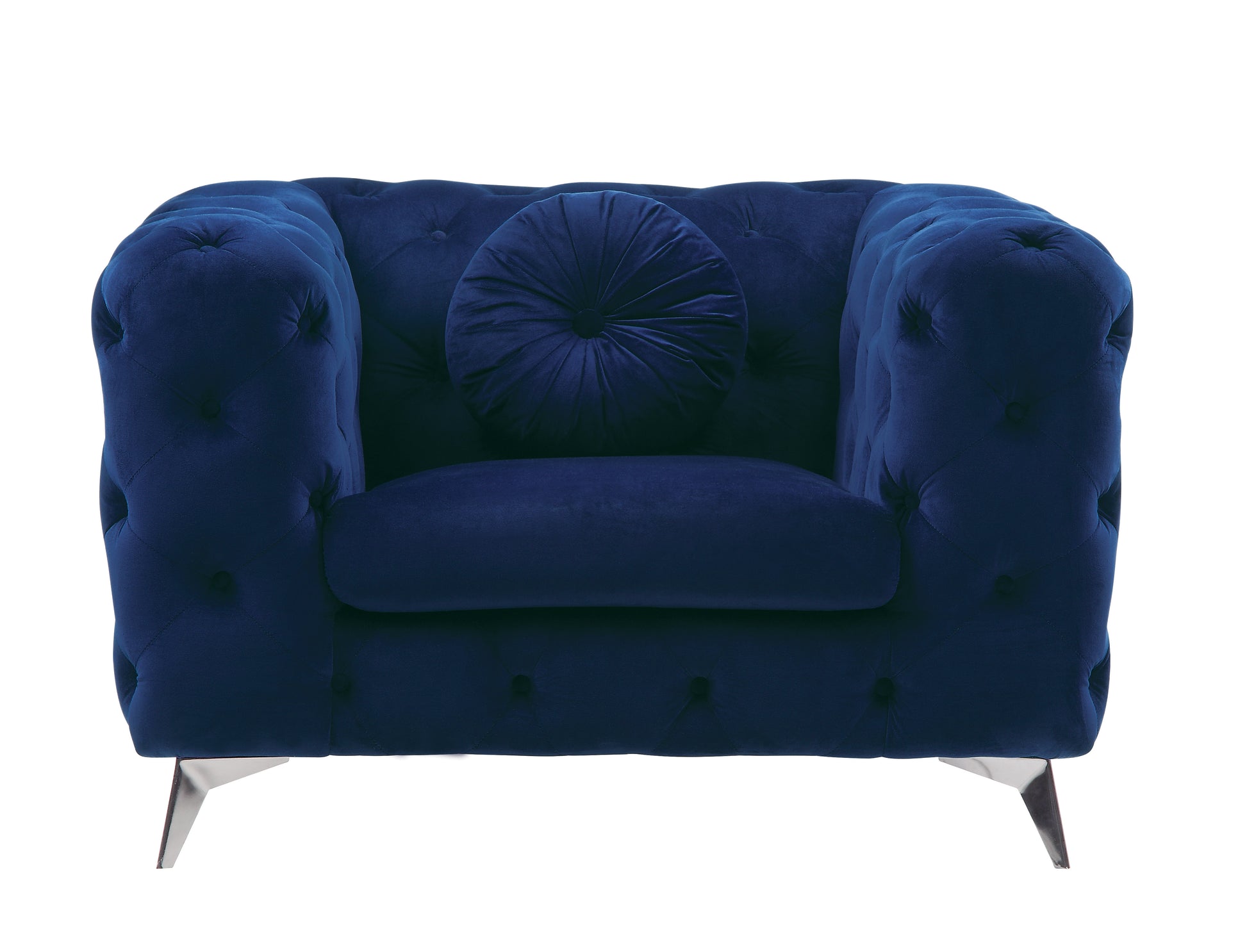 Deep blue velvet armchair with tufted detailing and a round lumbar pillow