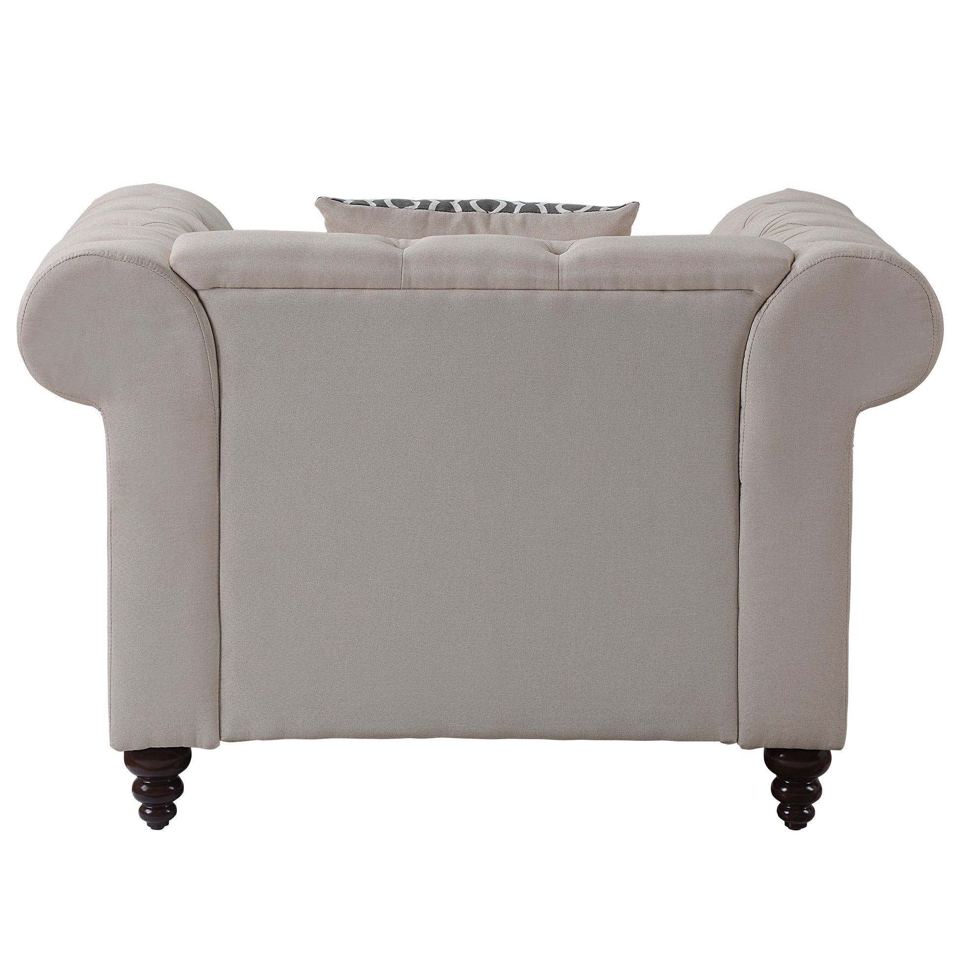 Beige upholstered chesterfield armchair with tufted back and patterned cushion