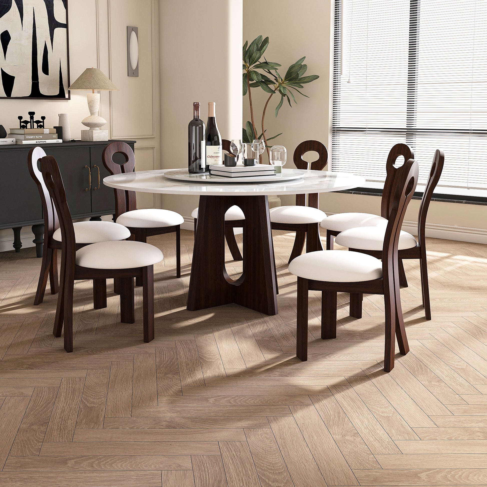 Modern white marble dining table with dark wood base and upholstered chairs