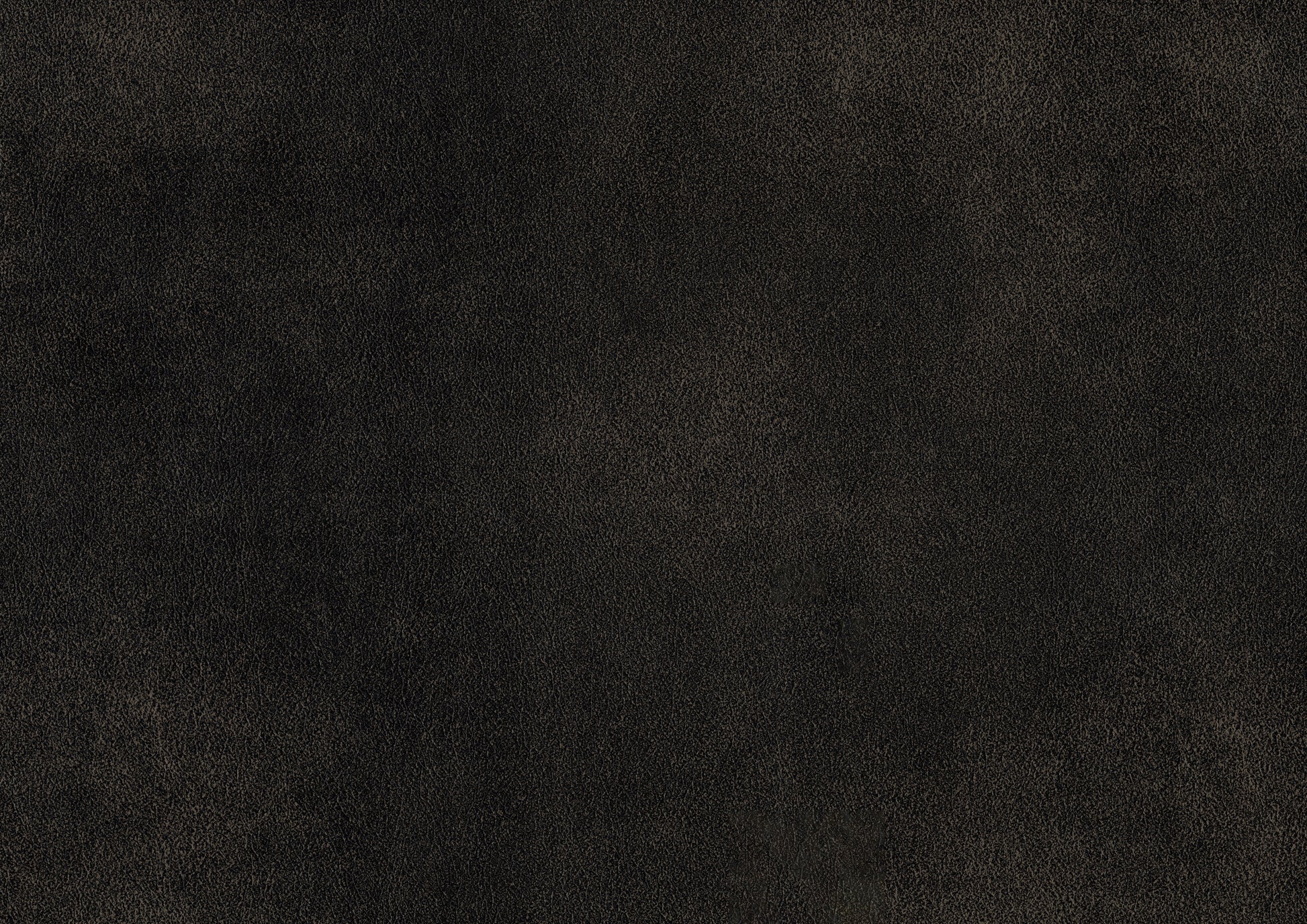 Textured dark brown faux leather fabric closeup for upholstery