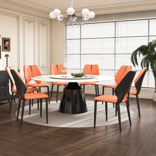 Modern orange faux leather dining chairs with black accents around a white marbletop table
