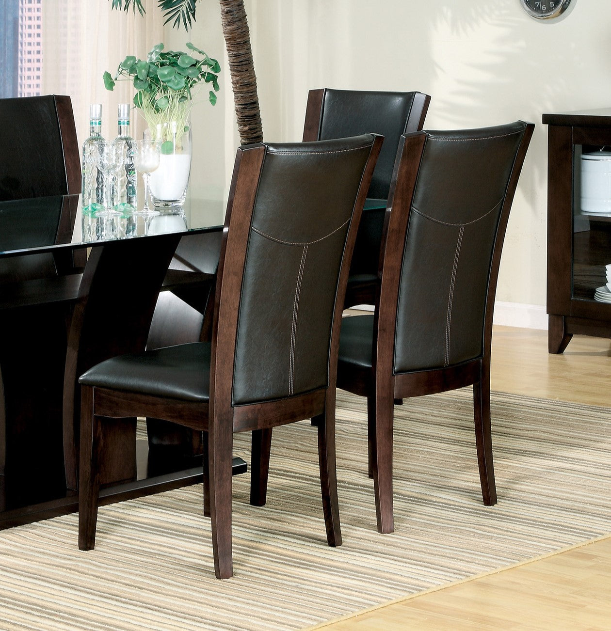 Dark brown upholstered dining chairs with wooden frame and stitched details