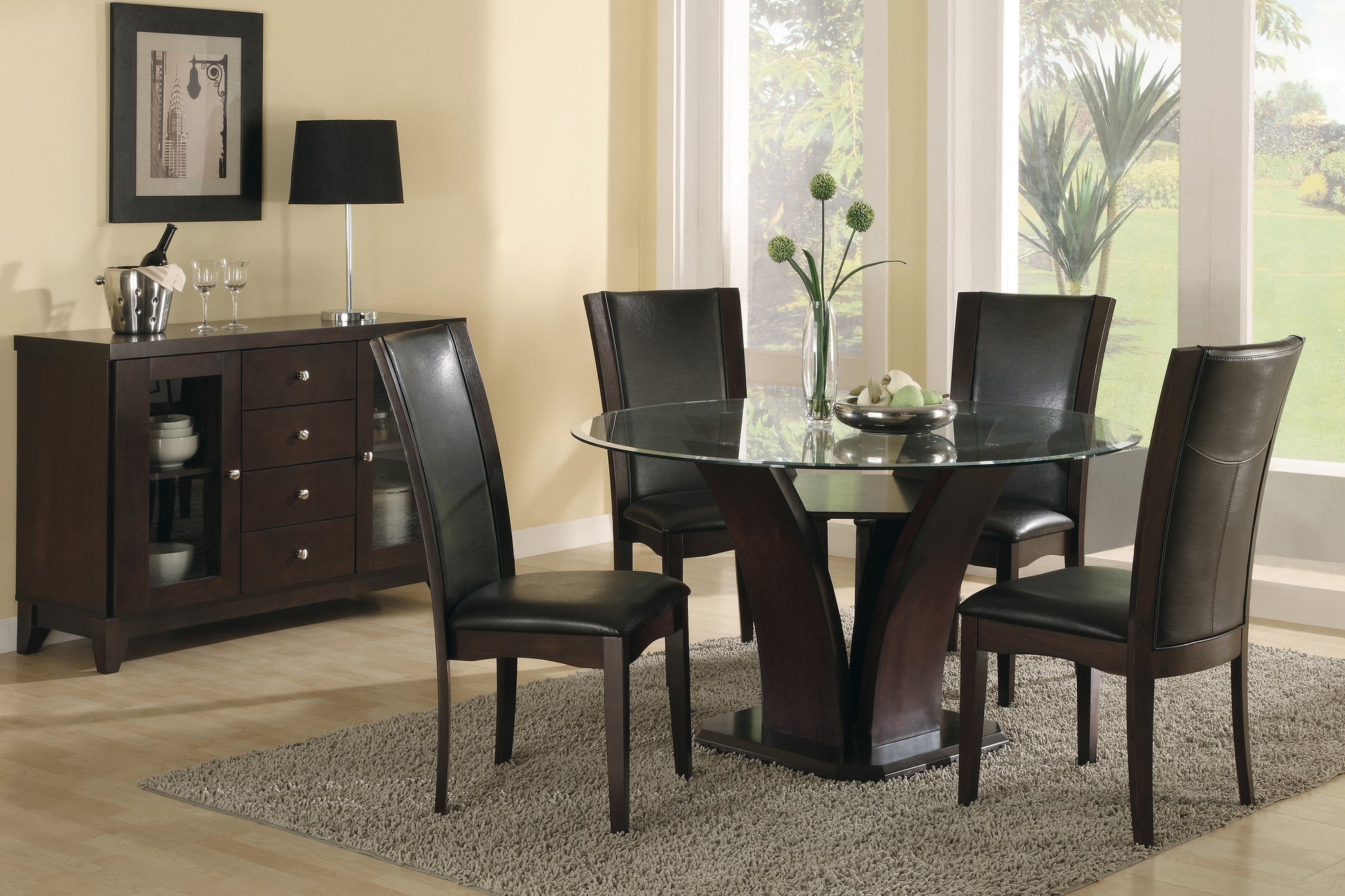 Glass top dining table with four dark brown leather chairs