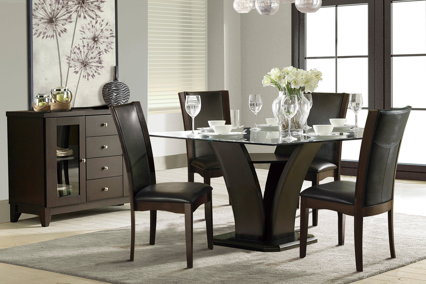 Modern dining set with glass top table and four dark leather chairs