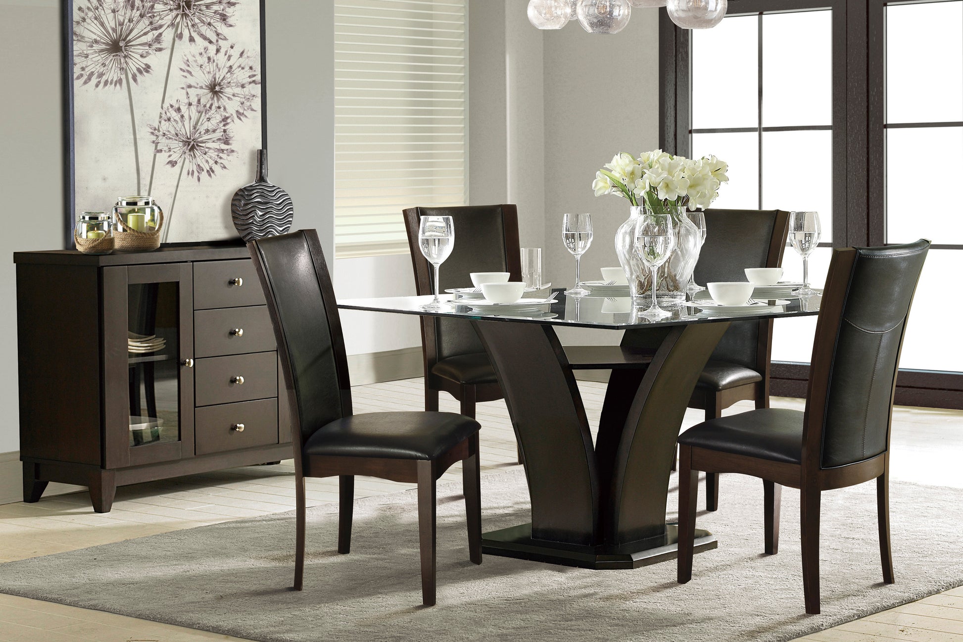 Modern dining set with glass top table and four dark leather chairs
