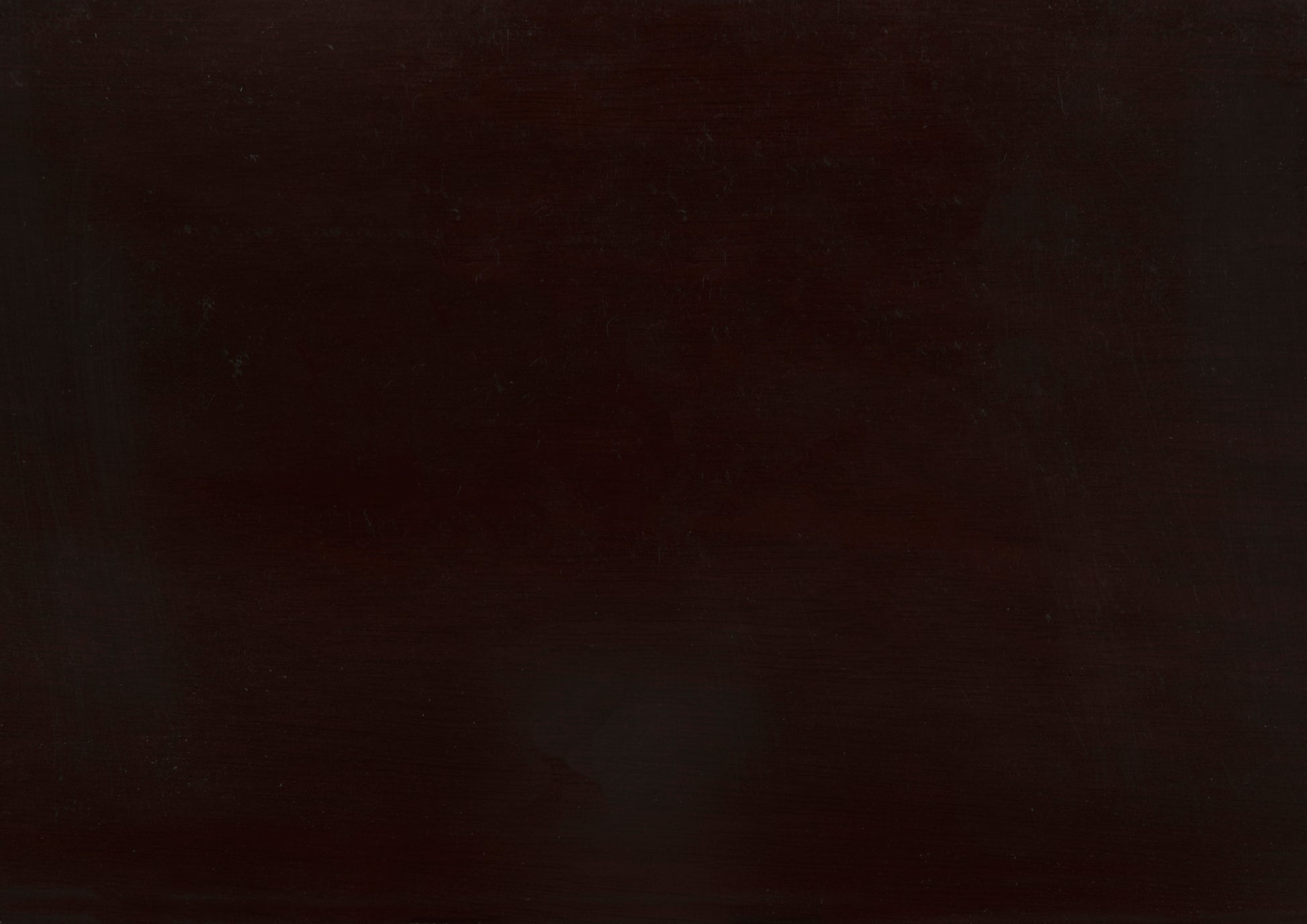 Dark brown polished wooden table surface with visible grain