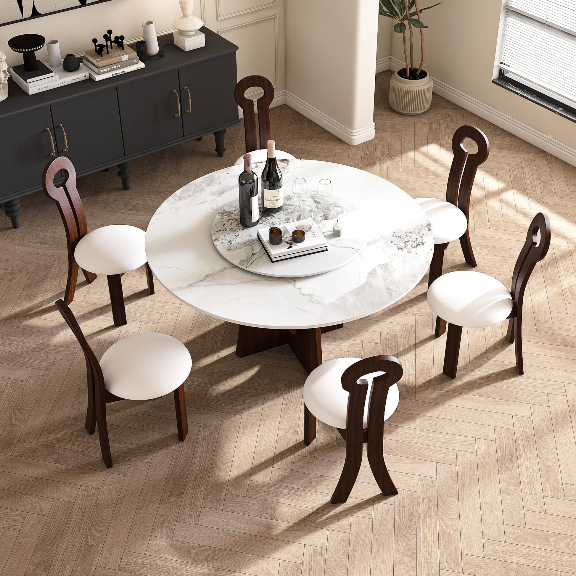 Modern marble dining table with six dark wood chairs and white cushions