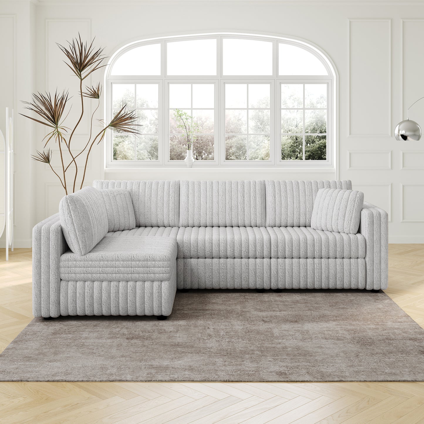 Light gray plush sectional sofa with ribbed texture and a chaise lounge