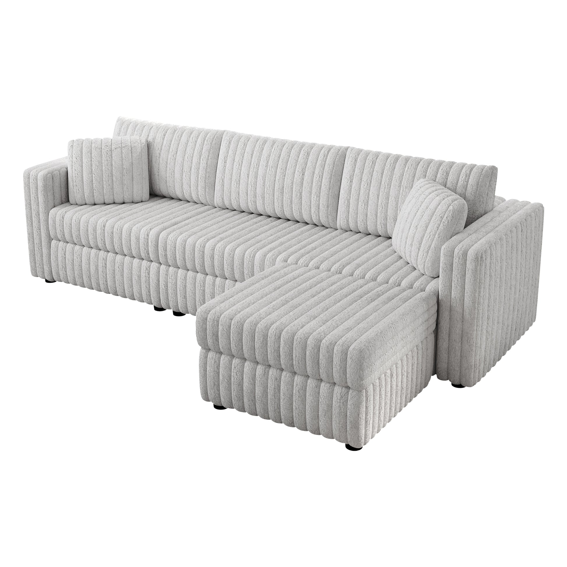Light grey plush sectional sofa with vertical channel tufting and throw pillows