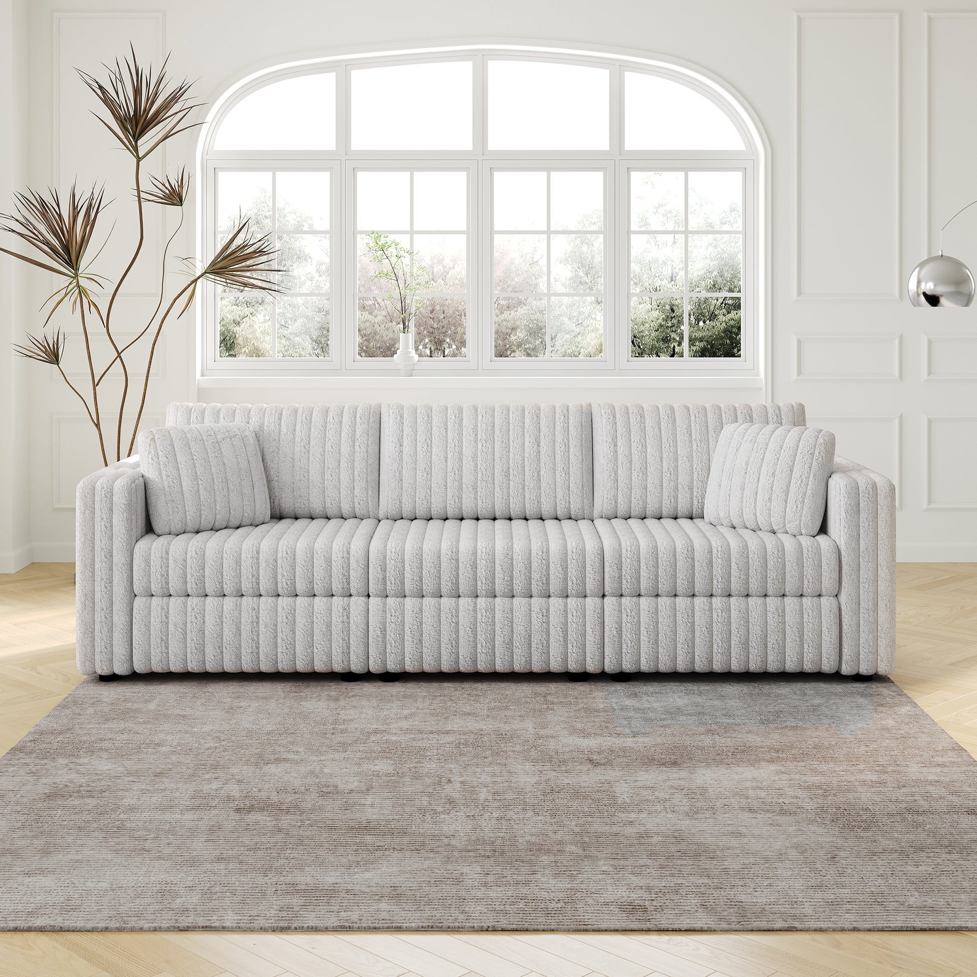Textured grey boucle fabric sofa with plush cushions and rounded arms