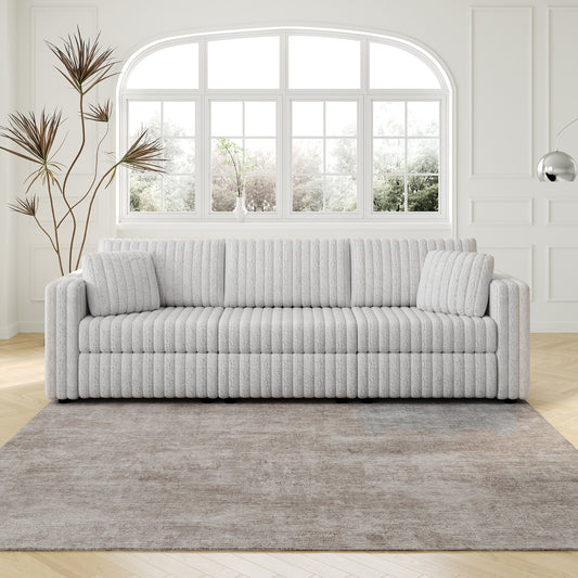 Textured grey boucle fabric sofa with plush cushions and rounded arms