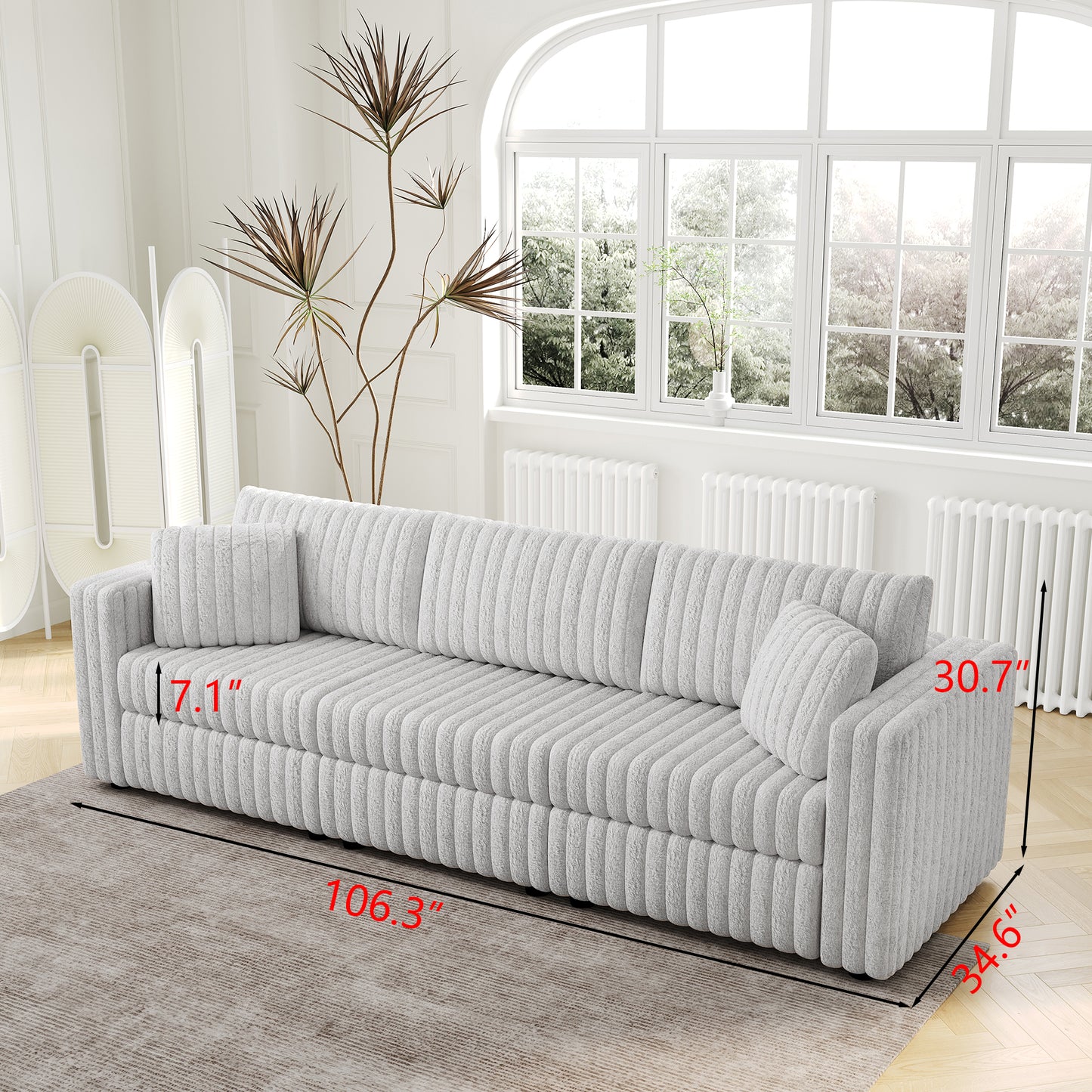 Light gray corduroy sofa with plush cushions and channel tufting  long