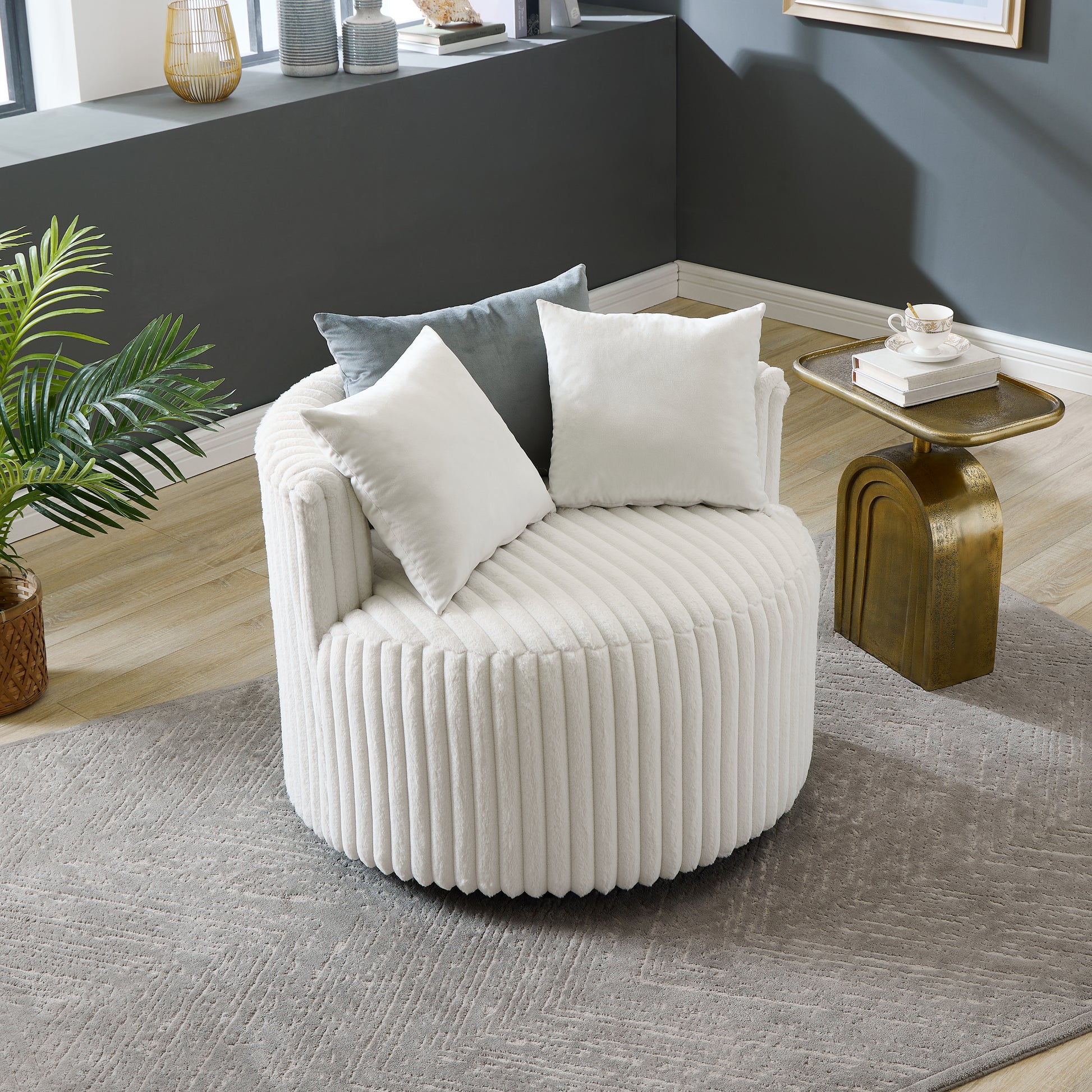 Plush white swivel chair with vertical ribbing and decorative pillows perfect for living room accent seating