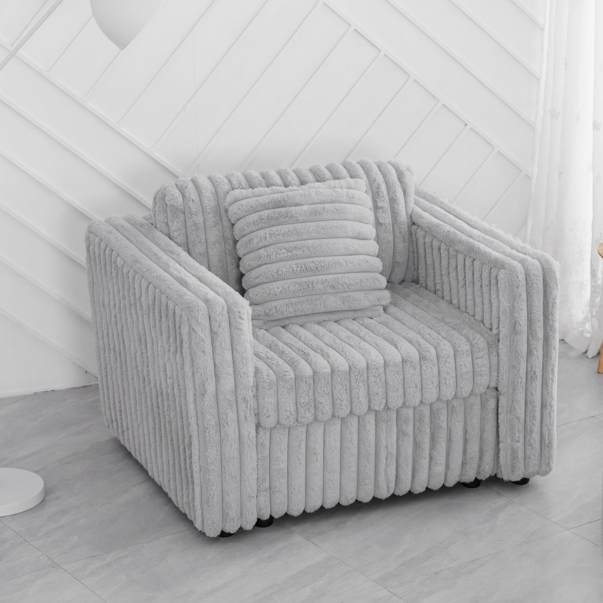 Plush corduroy armchair in light grey with matching throw pillow for cozy living room seating