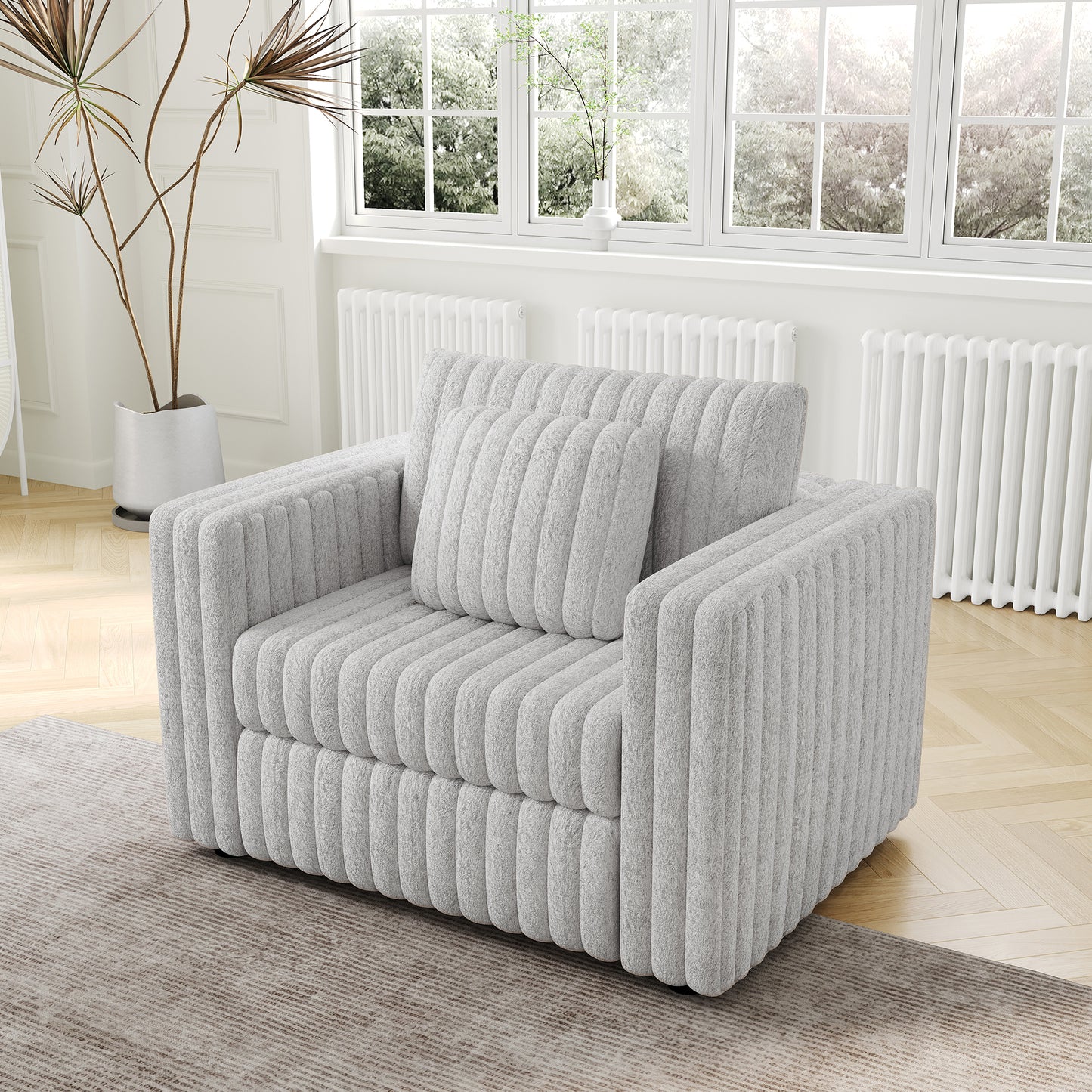 Plush grey armchair with vertical channel tufting and a matching throw pillow ideal for a cozy living room