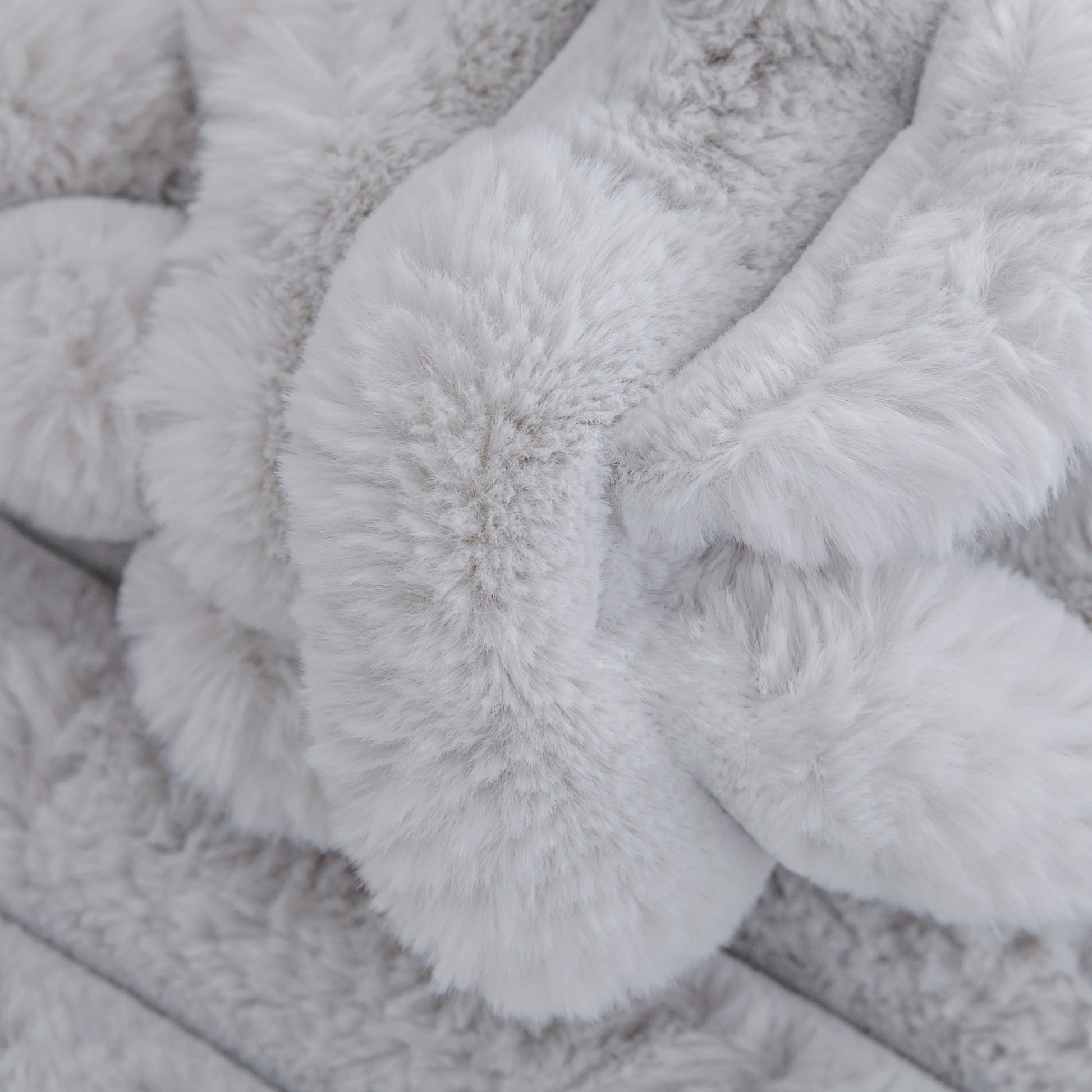 Soft grey faux fur throw blanket with a plush textured weave perfect for cozy home decor