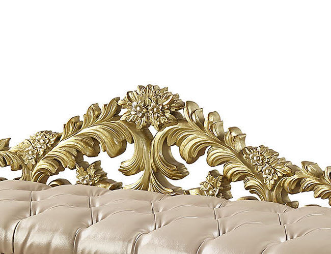 Antique gold ornate carved headboard detail with tufted cream upholstered bench