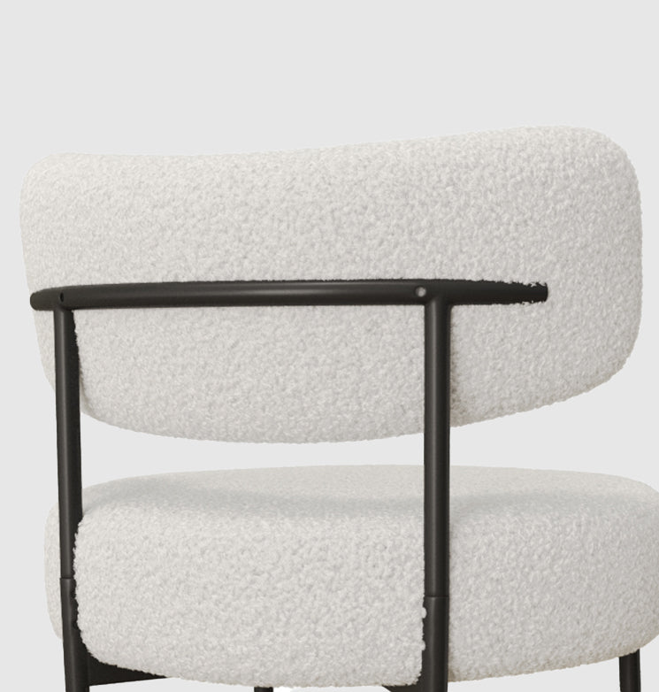 Plush ivory boucle accent chair with black metal frame for modern living rooms