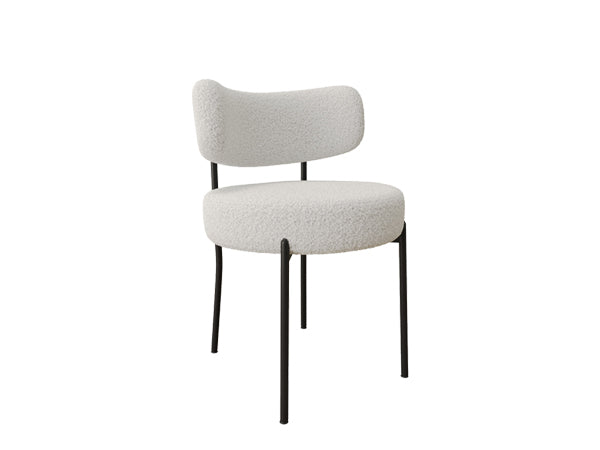Comfortable offwhite boucle dining chair with black metal legs perfect for modern interiors