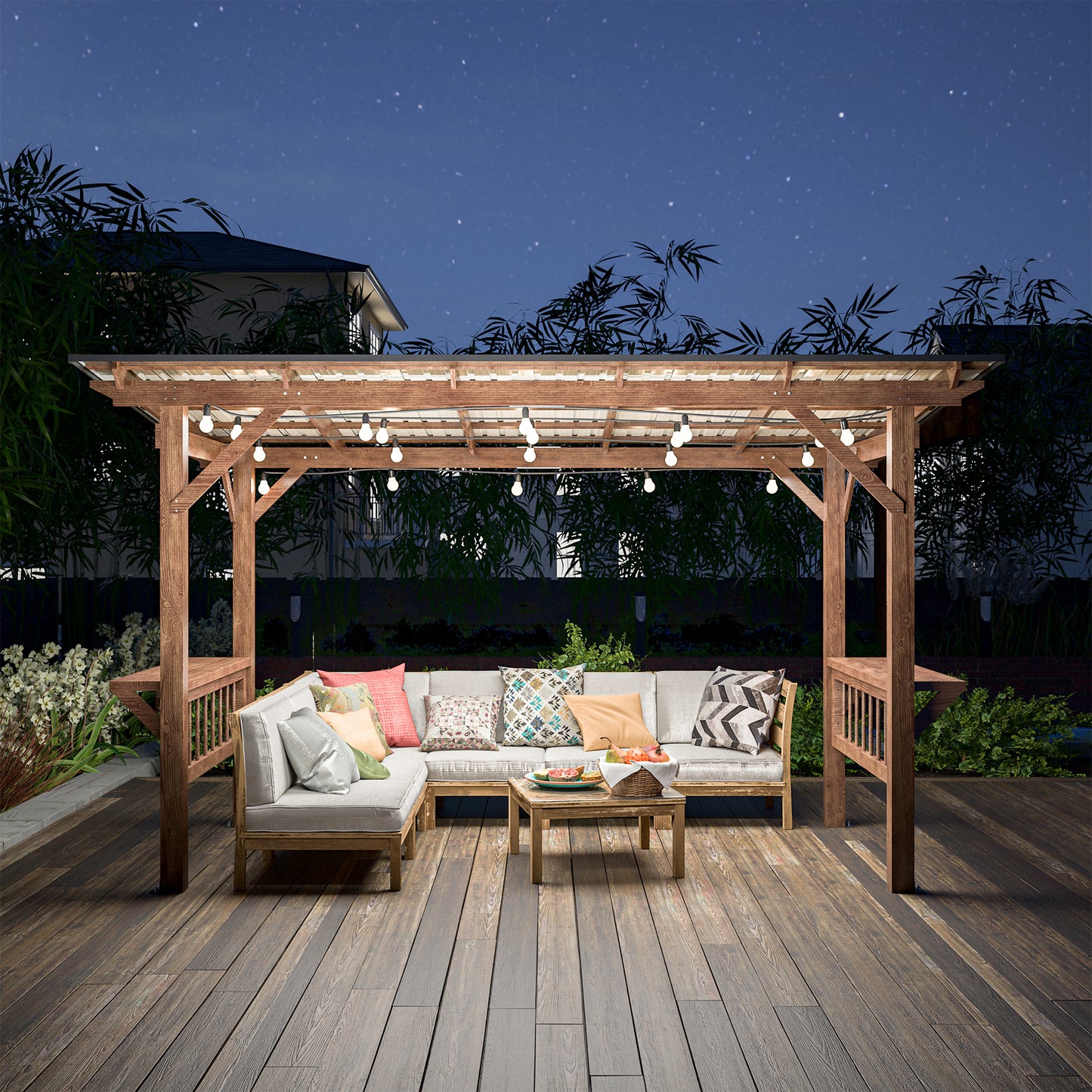Modern sectional patio furniture with decorative pillows under a wooden pergola at night