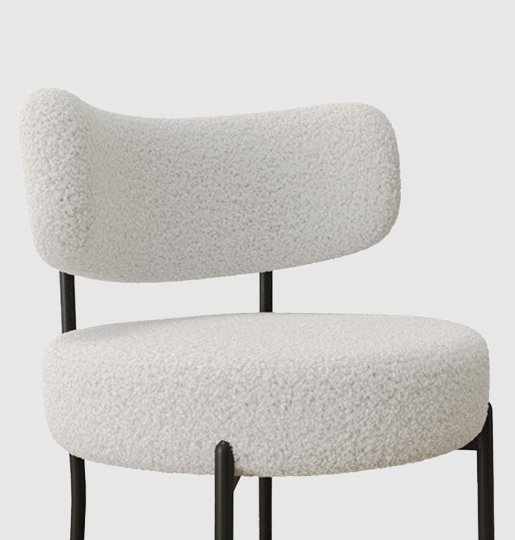 Plush white boucle armchair with black metal legs a cozy accent chair for any modern living room