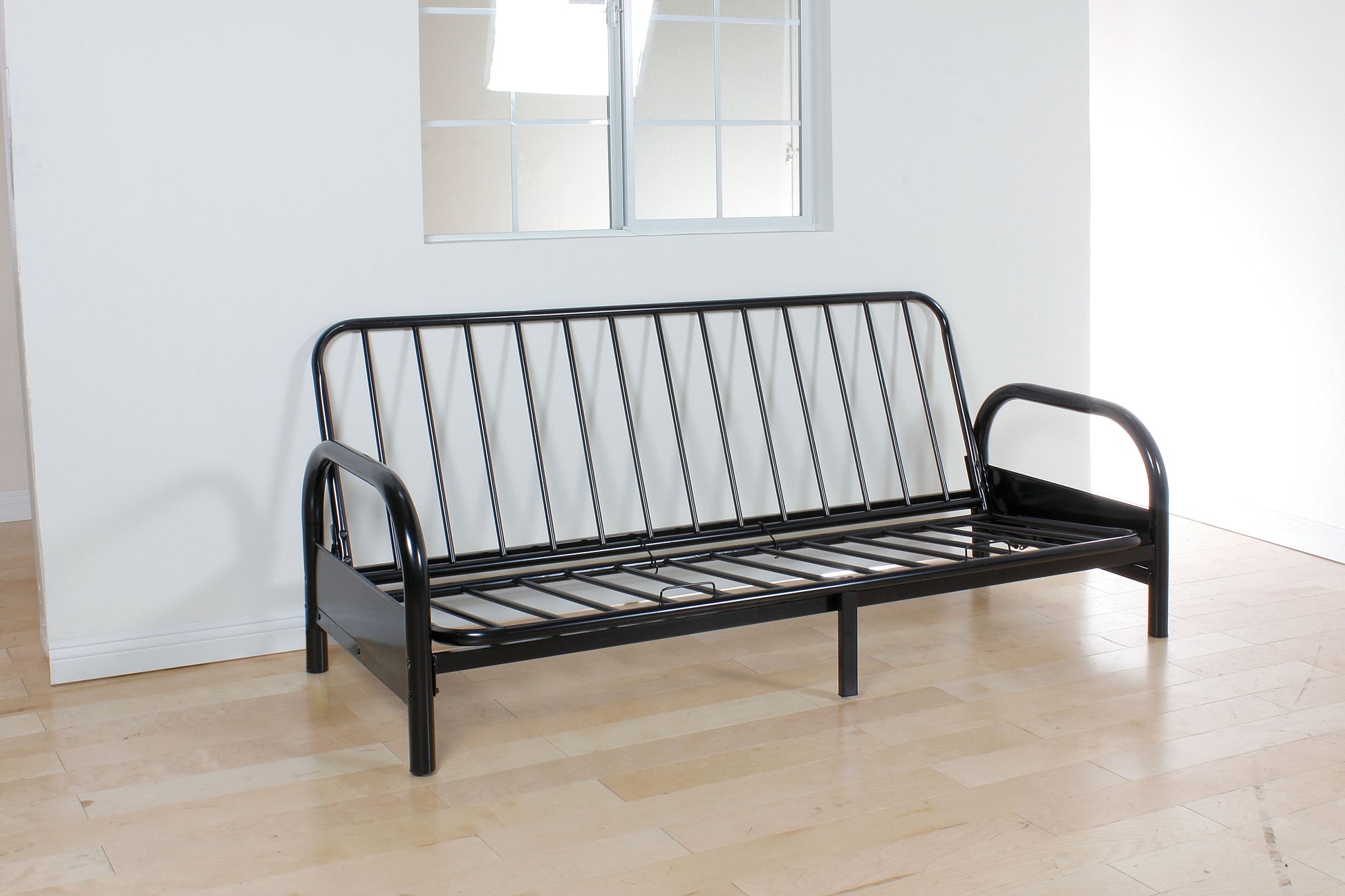 Black metal futon frame with clean lines ready for cushions for a versatile sofa bed