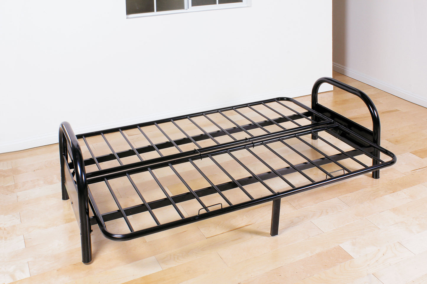 Black metal twin folding bed frame with a slatted surface ideal for guest rooms