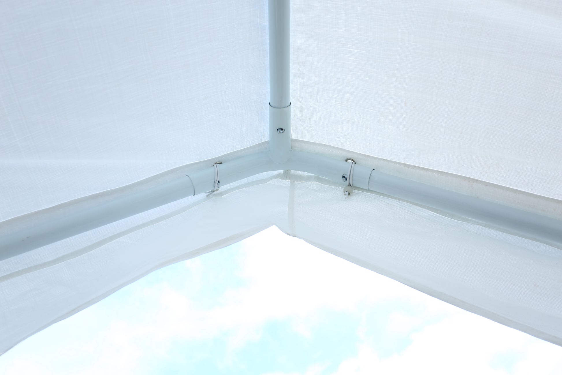 White canopy frame corner junction with white fabric roof providing shade