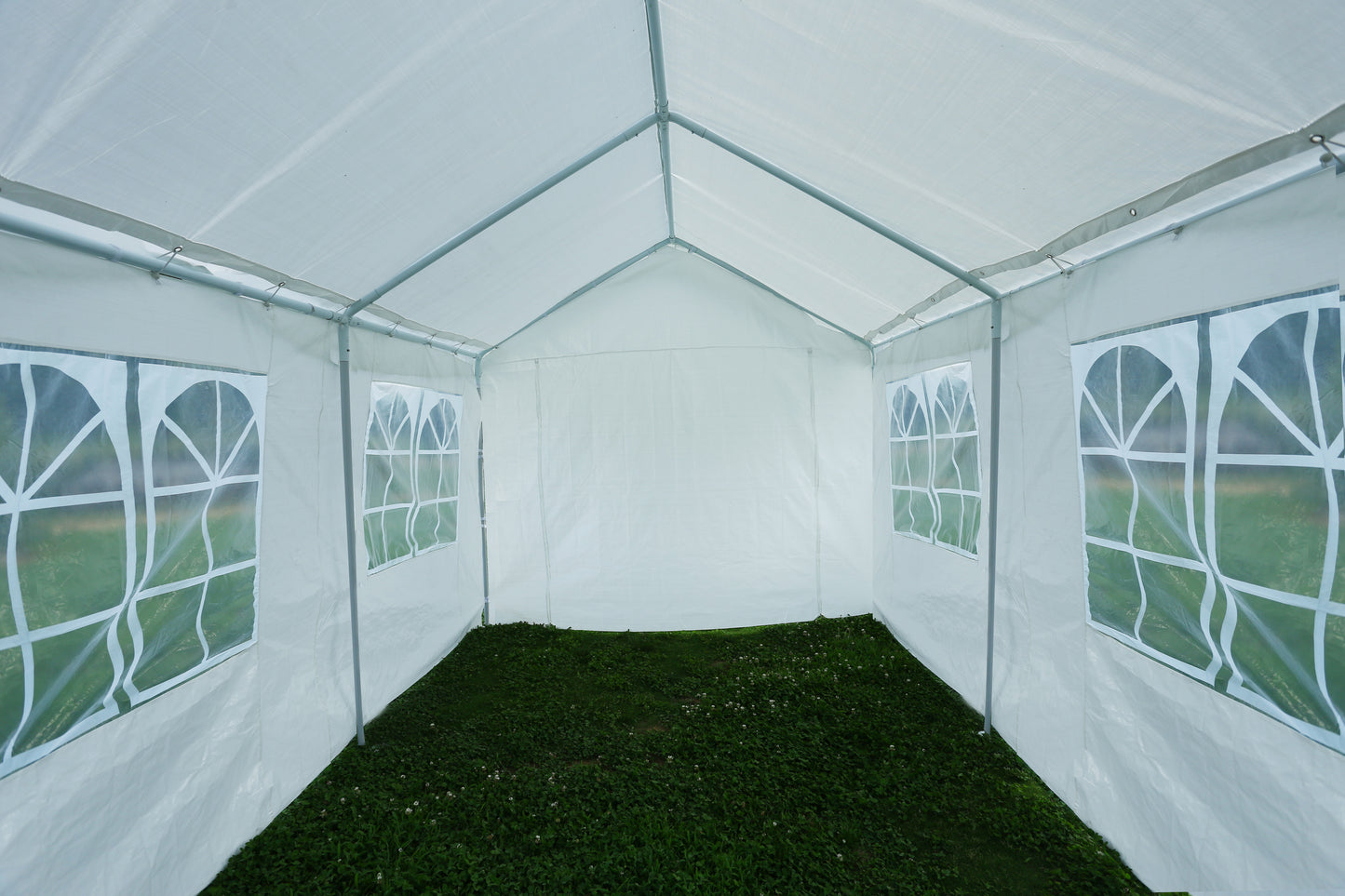 White party tent interior with arched windows suitable for outdoor events