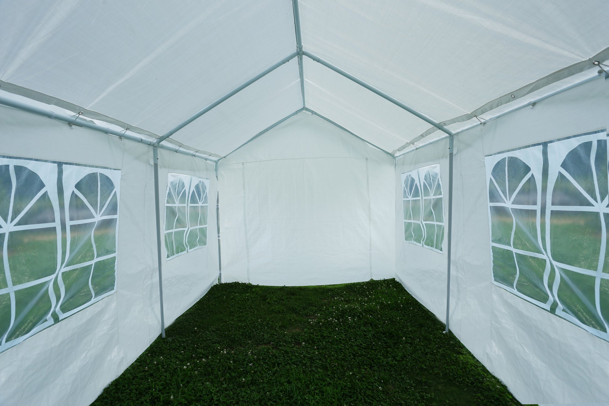 White party tent interior with arched windows suitable for outdoor events