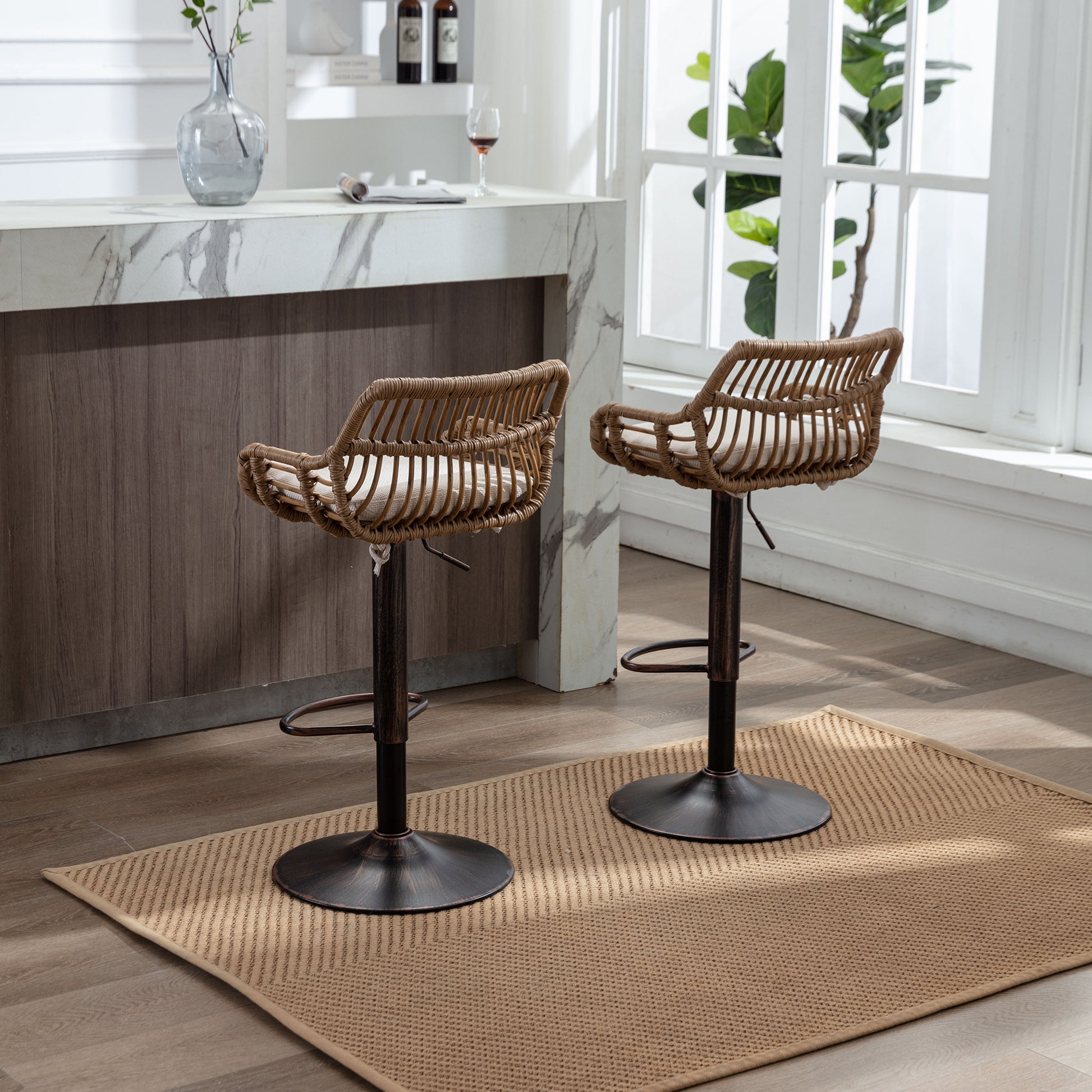 Natural rattan bar stools with adjustable height and plush cream cushions for a modern kitchen island setting