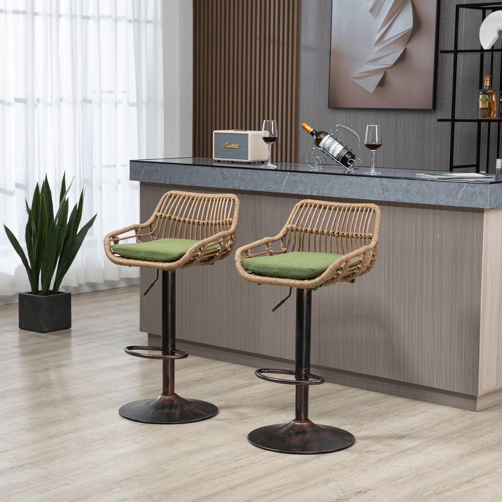 Two natural rattan bar stools with green cushions and bronze bases