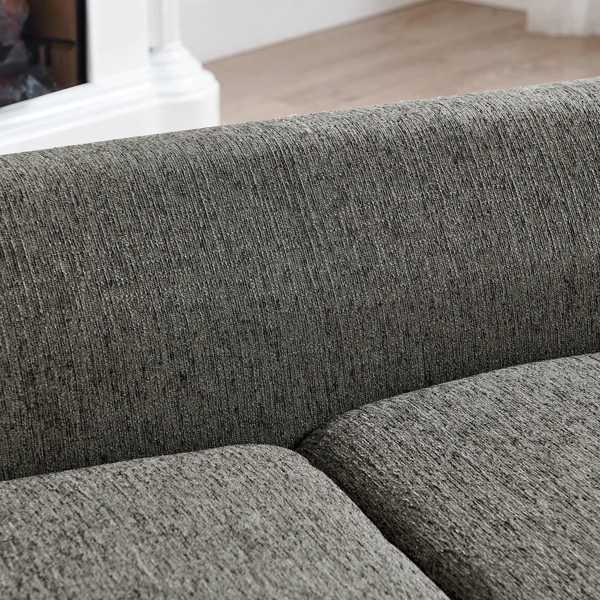 Closeup texture of charcoal grey woven fabric on a modern sofa cushion